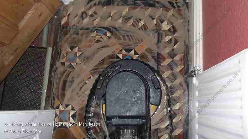 Machine scrubbing Victorian tiles carefully to avoid damaging soft clay surface
